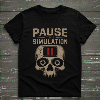 Black t-shirt with skull design and 'Pause the Simulation' text on a wooden surface.