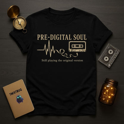 Black t-shirt with 'Pre-Digital Soul' design on a wooden surface with vintage items.