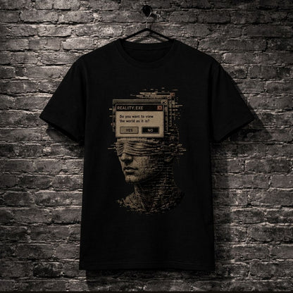A black short-sleeve graphic t-shirt hanging on a black hanger against a dark gray brick wall. The shirt features a distressed, pixelated graphic of a blindfolded face with a computer-style dialog box overlay reading 'REALITY EXE' and 'Do you want to view the world as it is, or as it was?'.