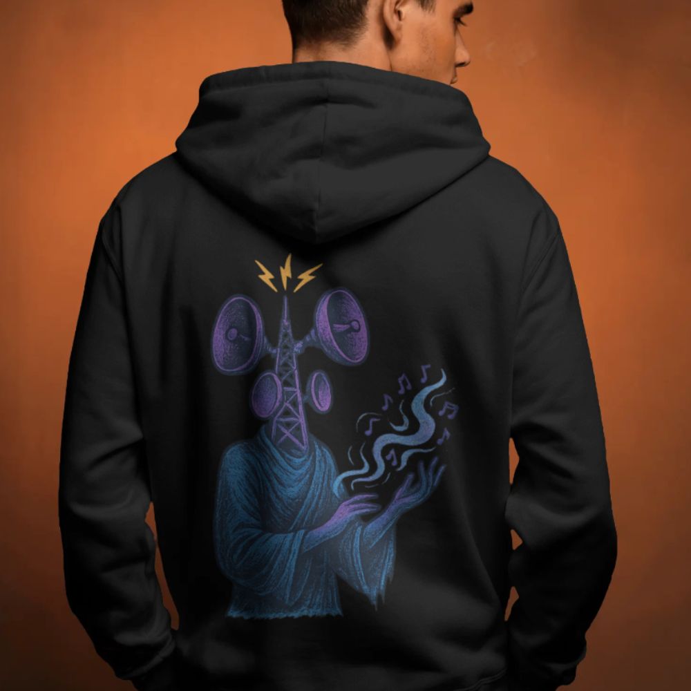 Model wearing black hoodie with surreal speaker-headed figure and sound waves on the back, dystopian streetwear style