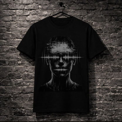 A black short-sleeve t-shirt hanging on a black hanger against a dark gray brick wall. The shirt features a large graphic print of a human face with a digital audio waveform overlay across the eyes.