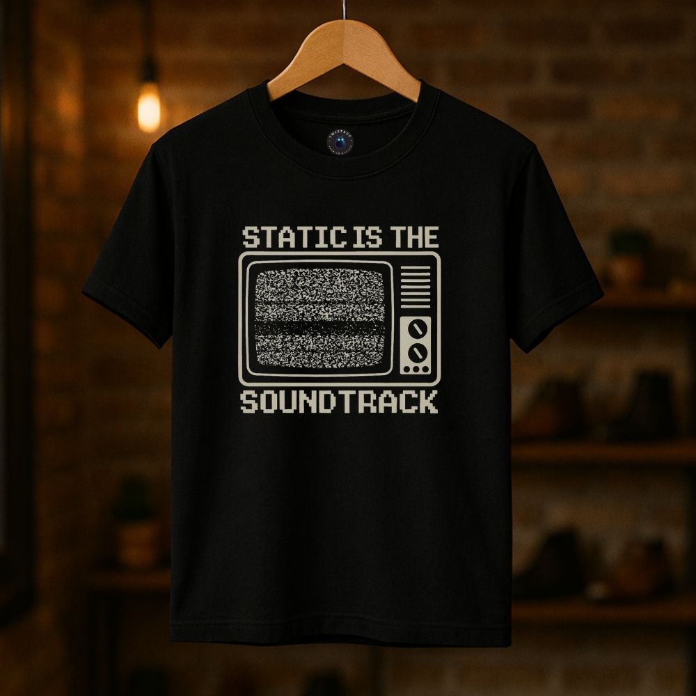 Black graphic T-shirt with “Static Is the Soundtrack” retro TV design on hanger
