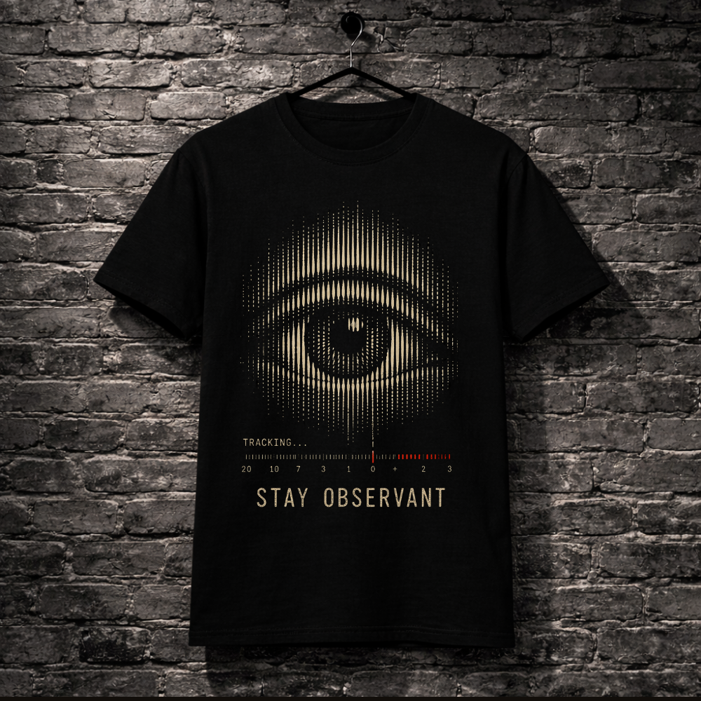 Black t-shirt with eye design hanging on a brick wall