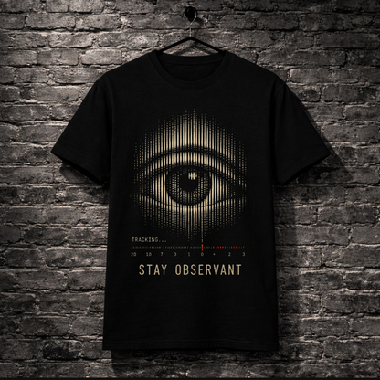 Black t-shirt with eye design hanging on a brick wall