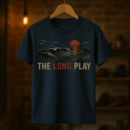 Navy blue t-shirt with 'The Long Play' design on a wooden hanger against a dark background