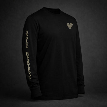 Black long sleeve t-shirt with pixelated heart chest graphic and “Analog Heartbeat” sleeve print in vintage bone color