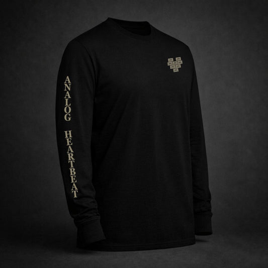 Black long sleeve t-shirt with pixelated heart chest graphic and “Analog Heartbeat” sleeve print in vintage bone color