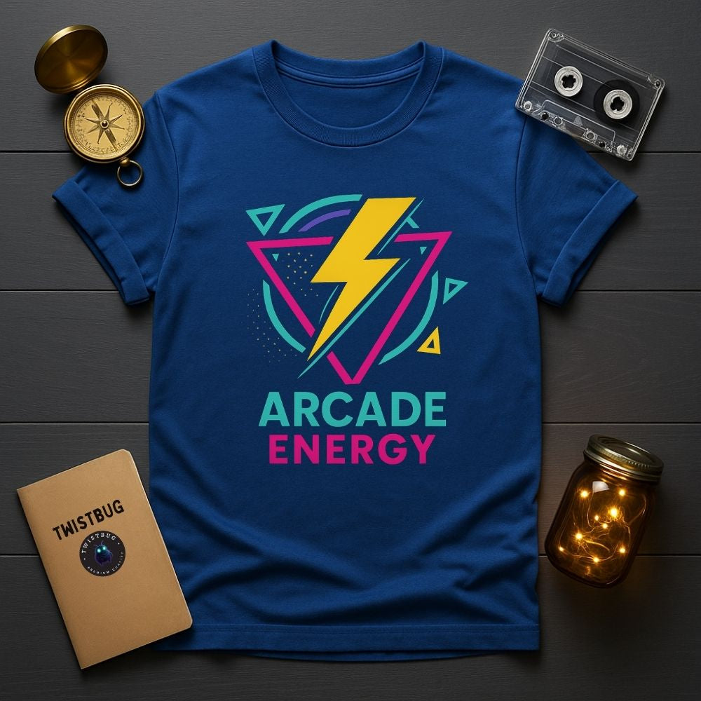 Flatlay of royal blue Arcade Energy T-shirt with bright retro lightning bolt graphic, cassette tape and notebook props, Twistbug tee