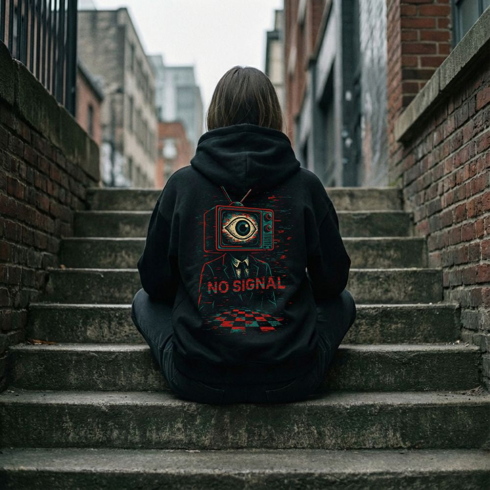 Woman wearing NO SIGNAL glitch TV hoodie sitting on outdoor stairs