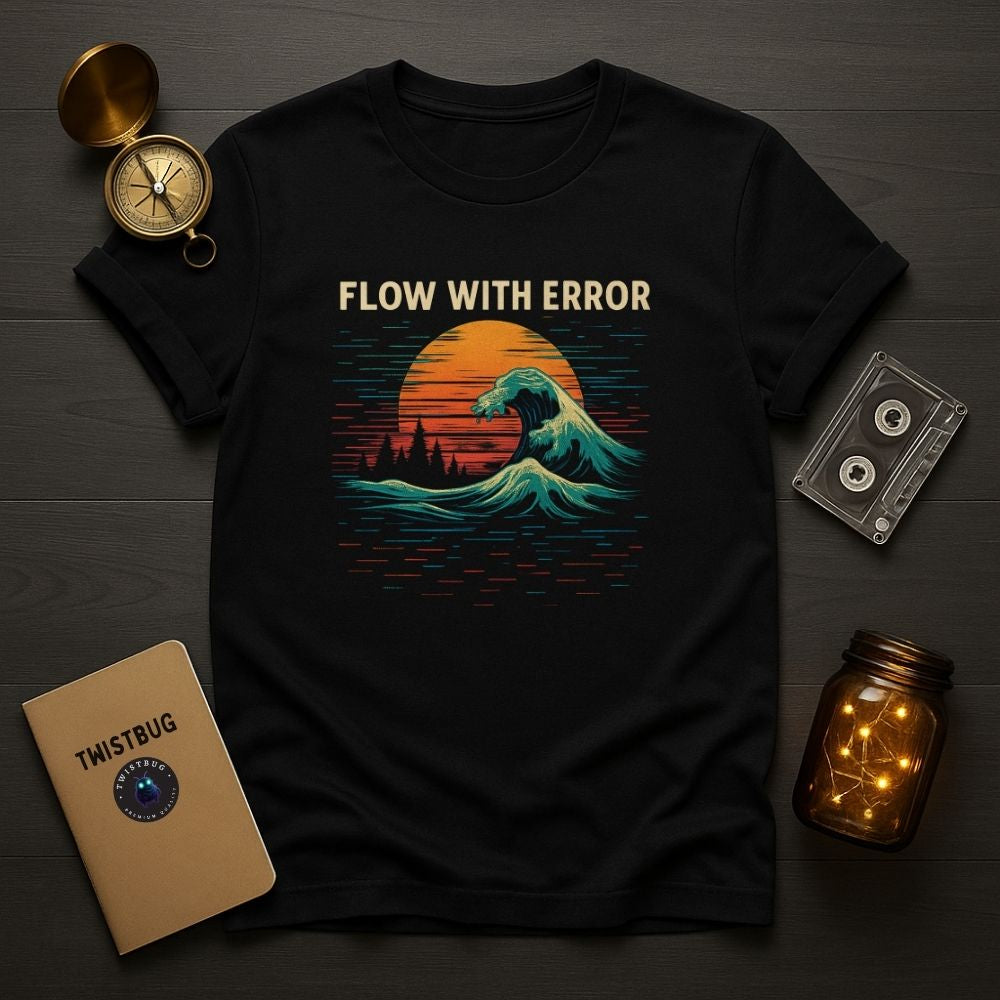Flat lay of black “Flow With Error” T-shirt beside Twistbug notebook, compass, and cassette on wooden desk.