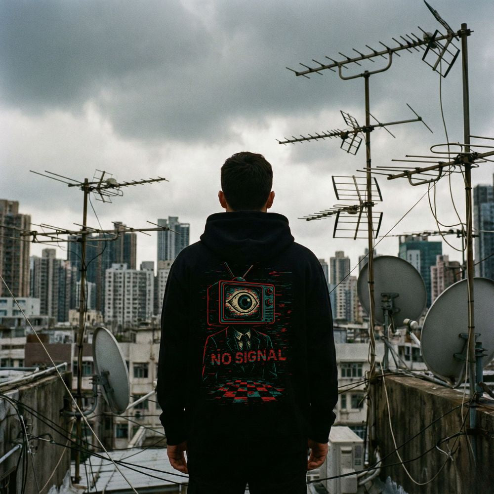Man wearing NO SIGNAL glitch TV hoodie on rooftop city background