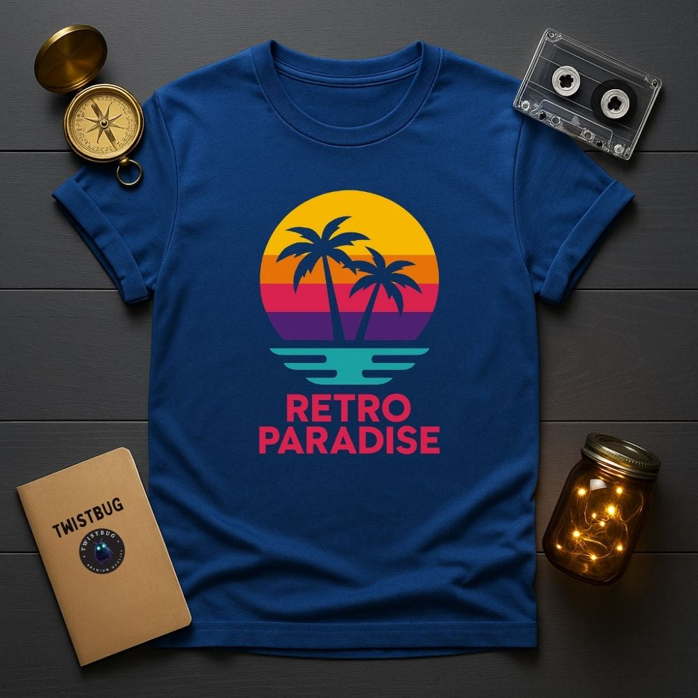 Flatlay of royal blue Retro Paradise T-shirt with retro sunset palm tree design, cassette tape and compass props, Twistbug design