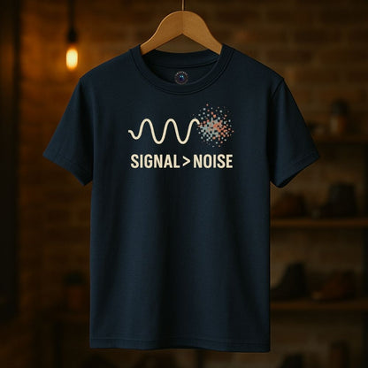 Navy Twistbug t-shirt on hanger showing minimalist ‘Signal > Noise’ graphic, cozy boutique lighting.