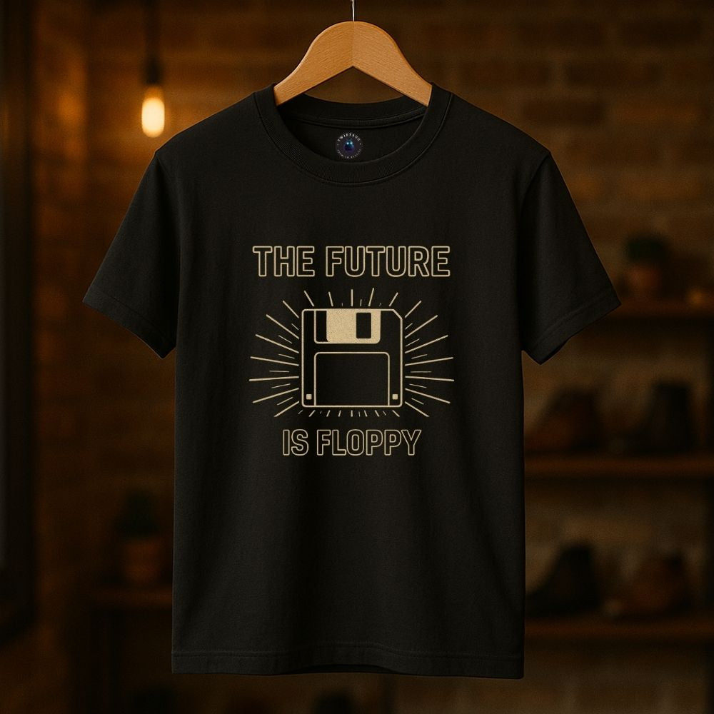 Black t-shirt with “The Future Is Floppy” floppy disk graphic hanging in a cozy analog-inspired room.