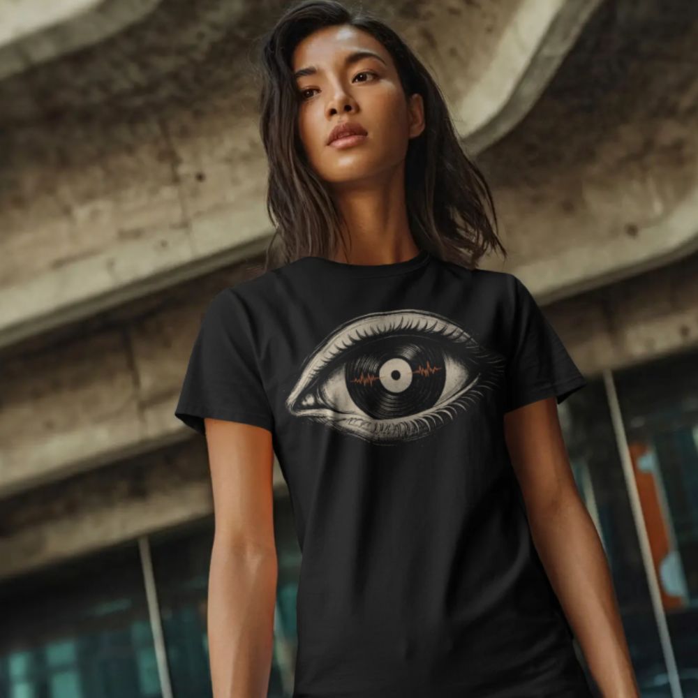 Person wearing a black t-shirt with an eye design in an urban setting