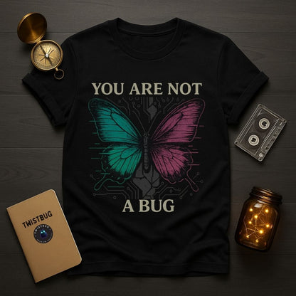 Black Twistbug graphic T-shirt with a cyberpunk butterfly and the phrase you are not a bug, flat lay with vintage props
