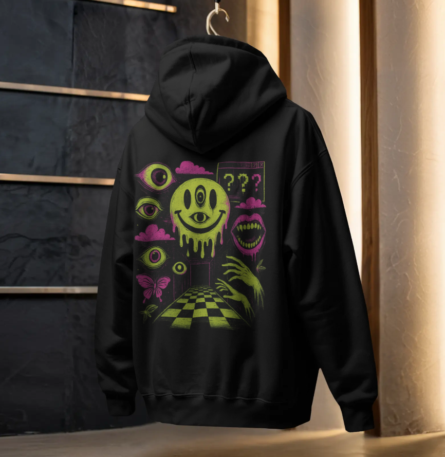 Black hoodie hanging on a rack showing a neon surreal smiley face and eyes graphic on the back