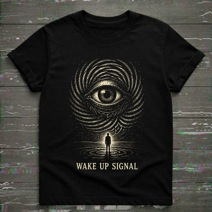 Black t-shirt with eye design and 'Wake Up Signal' text on a wooden surface