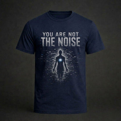 A navy blue short-sleeve t-shirt with a graphic print on the front. The print features the distressed white text 'YOU ARE NOT THE NOISE' above a dark silhouette of a human figure with a glowing blue chest light, set against a dark textured background.